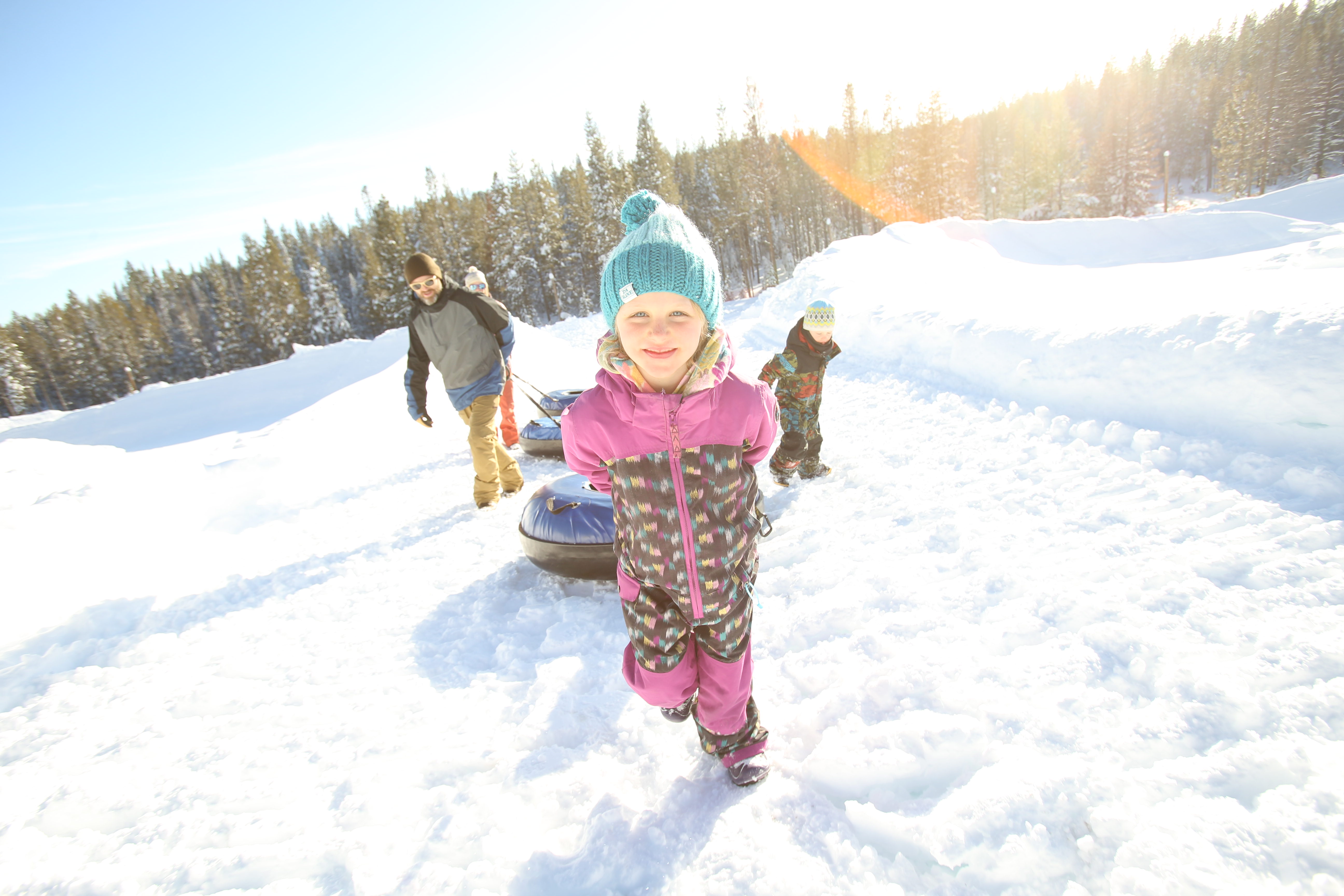 Snowshoeing through pine forests near Alder Creek Adventure Center in Tahoe Donner